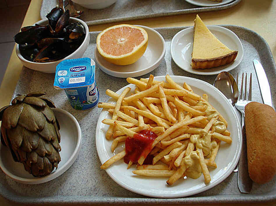 Saint Etienne, France, 2009. Mussels, grapefruit, lemon tart, roll, french fries, yogurt and an artichoke. 