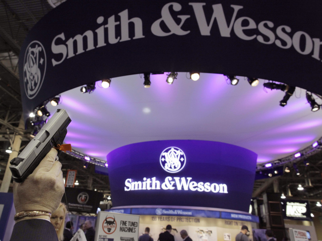 A retailer examines a Smith & Wesson hand gun at the Shooting, Hunting and Outdoor Trade show in Las Vegas, Jan. 18, 2011.