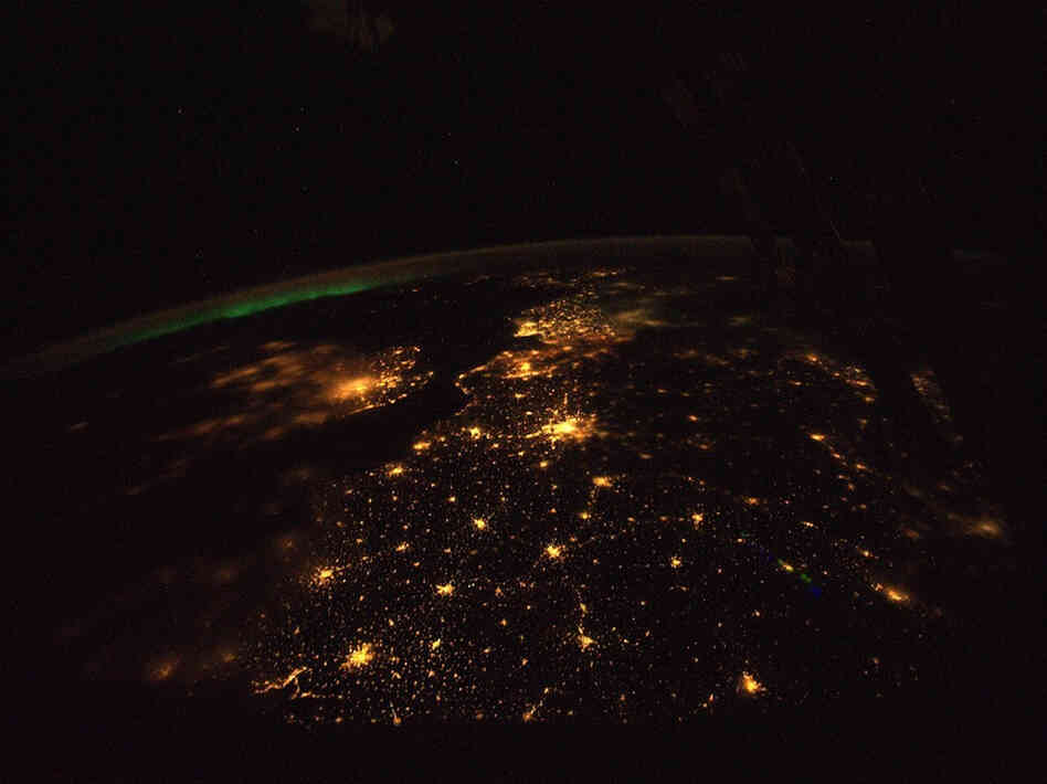 The English Channel,  shown here, lies between the light-polluted United  Kingdom, the smaller land mass to the left, and continental  Europe. London and its suburbs light up the image, just  left of center.