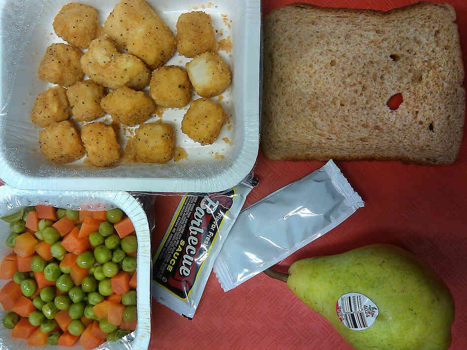 Illinois, 2010. Popcorn chicken, bread, pear, peas and carrots.