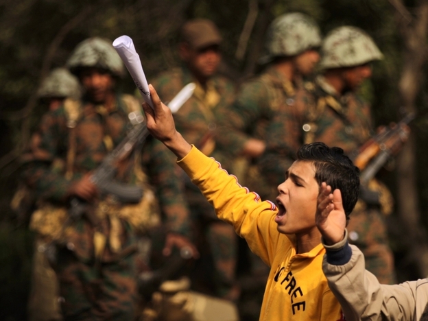 Demonstrators shout slogans next to Egyptian soldiers on  Feb. 1 as massive tides of protesters flood the Egyptian  capital's central Tahrir Square for the biggest outpouring of anger yet  in their relentless drive to oust President Hosni Mubarak's regime.