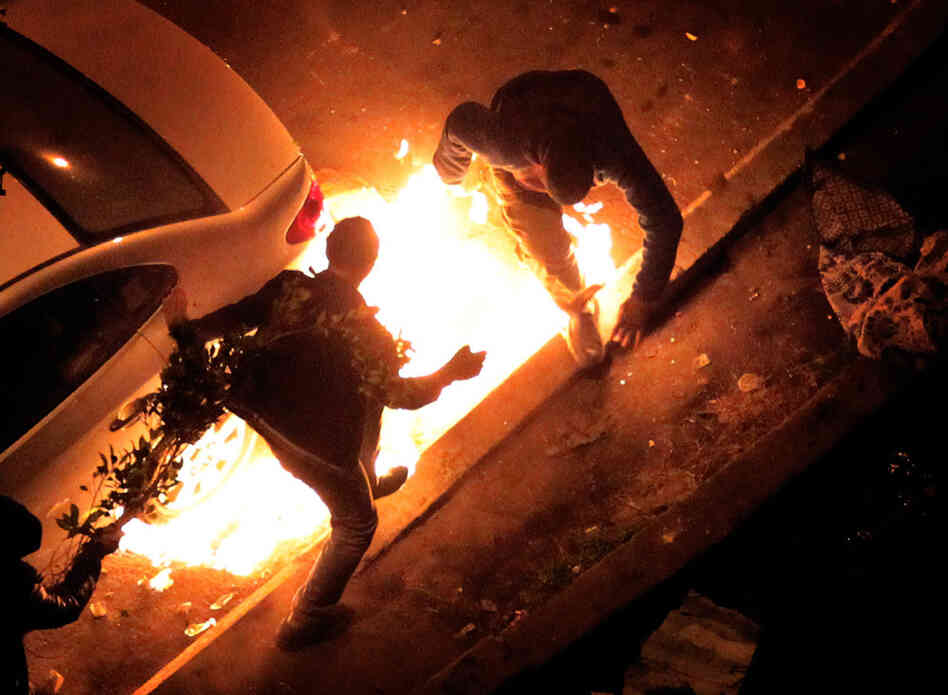 Anti-government protestors get caught by a petrol bomb thrown by pro President Mubarak supporters near Tahrir Square.