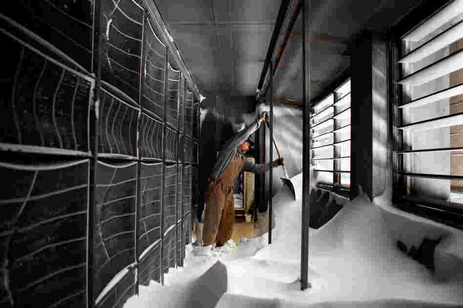 University of Iowa pipefitter Jeff Harland uses a shovel to dig out snow that had blown into the Carver Biomedical Research Building's air supply intake Wednesday in Iowa City, Iowa. 