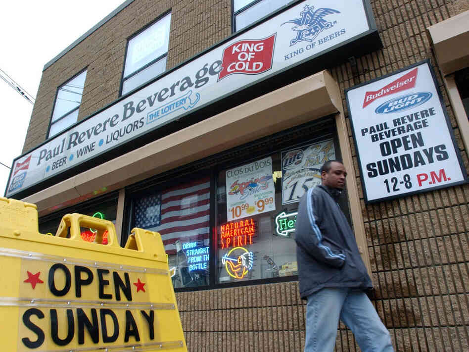 A pedestrian walks past Paul Revere Beverage in Somerville, Mass., in this photo from 2004 — the year the state ended its ban on Sunday alcohol sales. Since 2002, 14 states and numerous municipalities have repealed such bans.