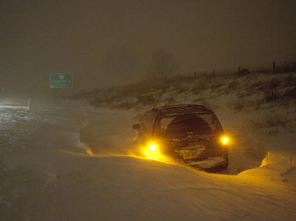 A vehicle is stranded on Interstate 43 Wednesday, Feb. 2, 2011, in Grafton, Wi. The area is under a blizzard warning and some freeways were shut down.