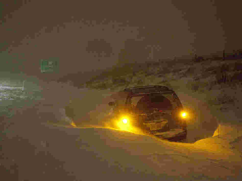 A vehicle is stranded on Interstate 43 Wednesday, Feb. 2, 2011, in Grafton, Wi. The area is under a blizzard warning and some freeways were shut down.
