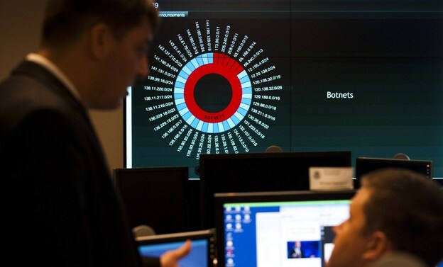 Analysts talk at the National Cybersecurity and Communications Integration Center, an element of the Department of Homeland Security based in Arlington, Va.