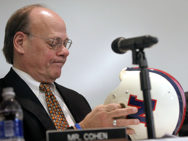 Steve Cohen, a member of the House Judiciary Committee, examines the helmet of Lem Barney, a former player for the Detroit Lions. A committee hearing last year evaluated steps taken at the professional, college and high school levels to deal with football brain injuries.