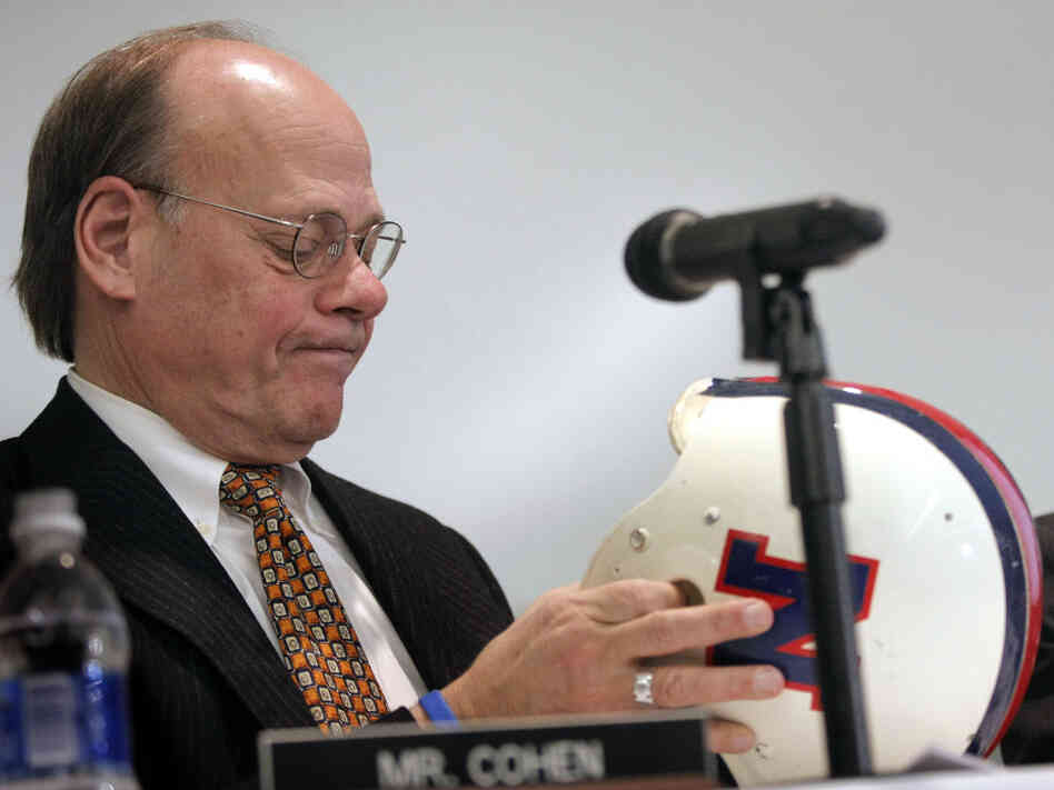 Steve Cohen, a member of the House Judiciary Committee, examines the helmet of Lem Barney, a former player for the Detroit Lions. A committee hearing last year evaluated steps taken at the professional, college and high school levels to deal with football brain injuries.