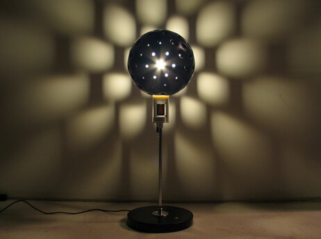 A lamp shade robot, an Auger-Loizeau Carnivorous Domestic Robot Entertainment design, is powered by incoming flies. A lamp shade robot, an Auger-Loizeau Carnivorous Domestic Robot Entertainment design, is powered by incoming flies.