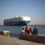 A cargo ship transits the Suez Canal en route from the Mediterranean Sea to the Gulf of Suez at the city of Suez, Egypt, on Wednesday. A cargo ship transits the Suez Canal en route from the Mediterranean Sea to the Gulf of Suez at the city of Suez, Egypt, on Wednesday.