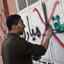 A pro-Mubarak supporter paints slogans over anti-Mubarak graffiti. This is the photo that Burton took right before he was attacked.