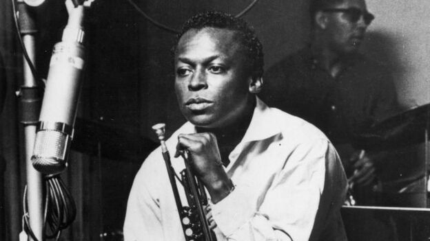 American jazz trumpeter and composer Miles Davis (1926 - 1991), sits with his instrument during a studio recording session, October 1959. (Photo by Hulton Archive/Getty Images)