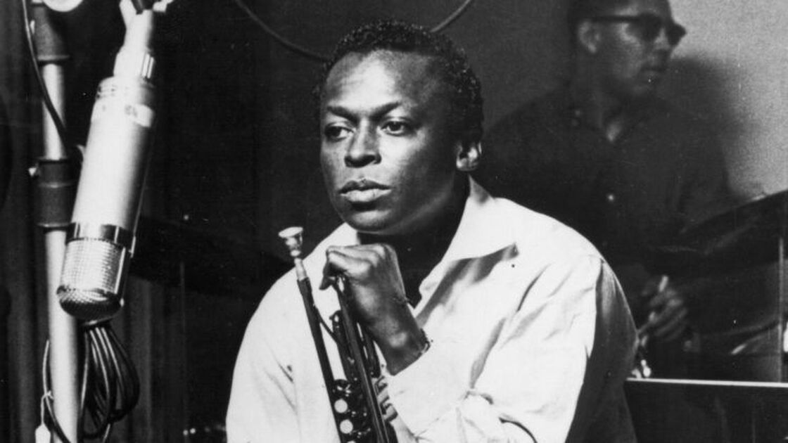 American jazz trumpeter and composer Miles Davis (1926 - 1991), sits with his instrument during a studio recording session, October 1959. (Photo by Hulton Archive/Getty Images)