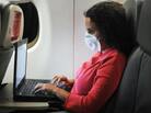 An airline passenger wears a mask to protect against viruses. Passengers are at risk of becoming infected in the airplane's cabin, just as they would be in any crowded, confined space. An airline passenger wears a mask to protect against viruses. Passengers are at risk of becoming infected in the airplane's cabin, just as they would be in any crowded, confined space.
