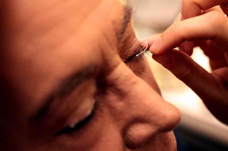 Actress Sara Topham, who plays ingenue Gwendolen Fairfax, applies the false eyelashes. Topham is a member of the acting company at the Stratford Shakespeare Festival — where Bedford has played her fiancé, her father and now, her mother.