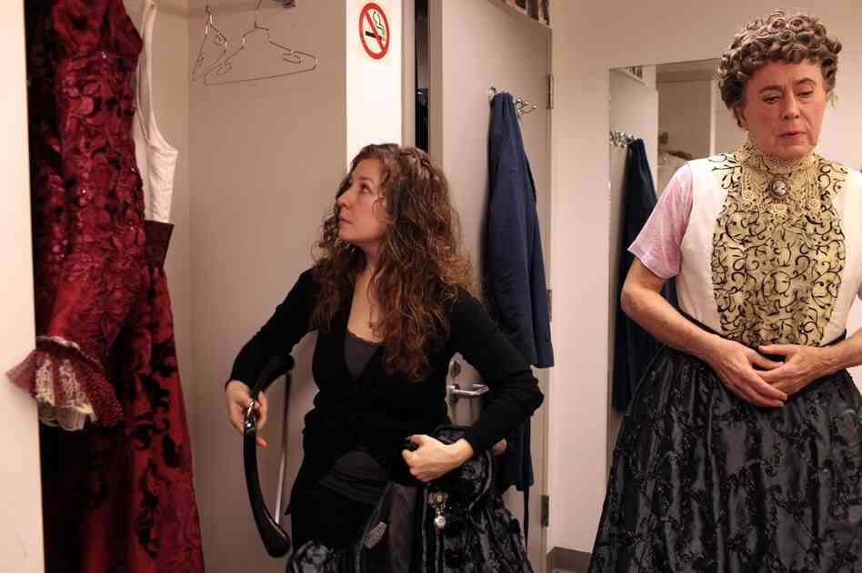 With Act 1 approaching, dresser Kat Martin helps Bedford get into Desmond Heeley's elaborate Victorian costume.