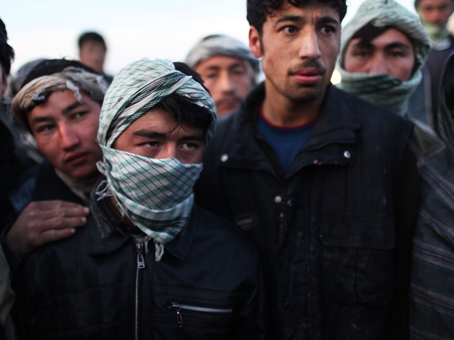 Unemployed men gather on a street corner waiting for pick-up work in Kabul, Afghanistan, in Jan. 2010. Afghanistan is still plagued by  chronic unemployment and neglected public services.