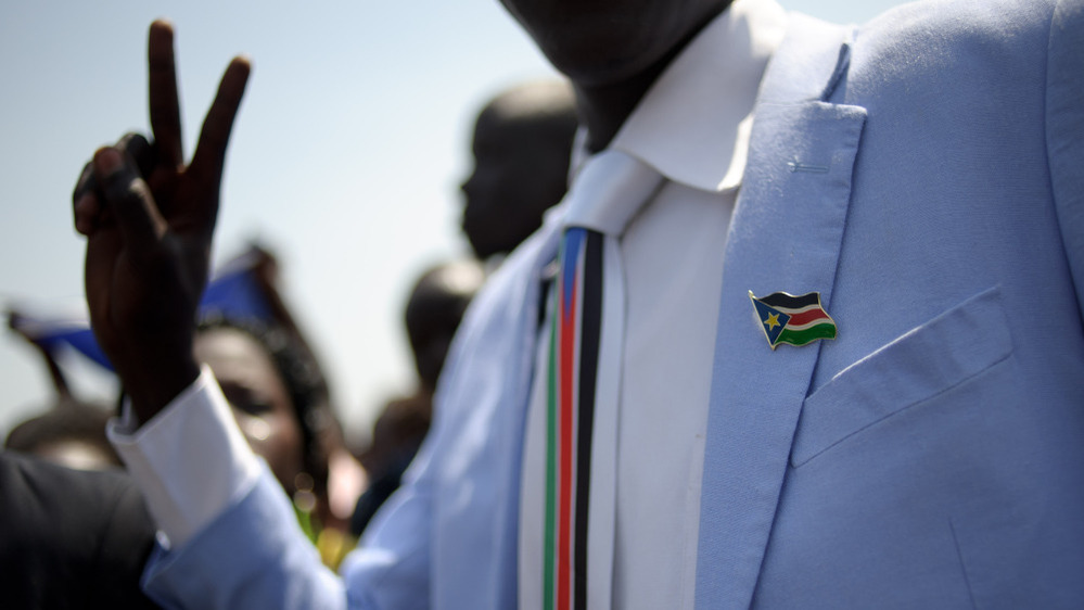 A man dressed in Southern Sudan paraphernalia — a pin and tie — celebrated the earlier announcement of the preliminary results.