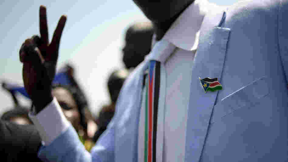 A man dressed in Southern Sudan paraphernalia — a pin and tie — celebrated the earlier announcement of the preliminary results.