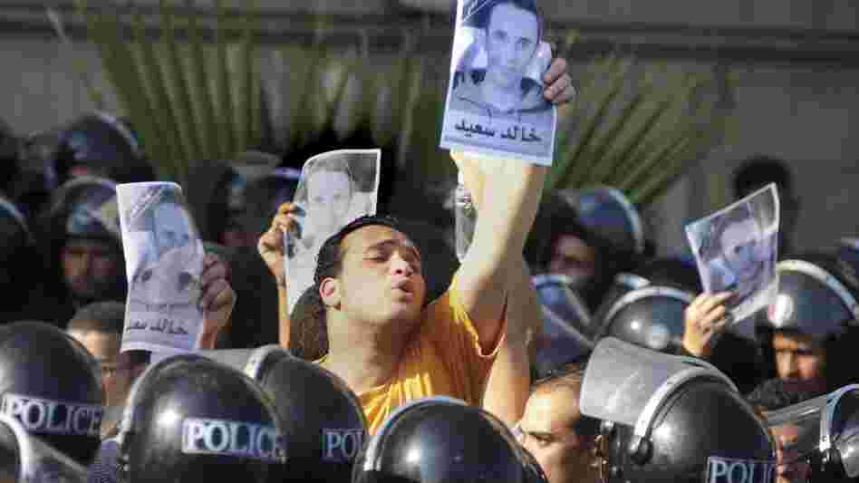 Egyptians shout anti-police slogans and hold up posters of 28-year-old  Khaled Said during a demonstration in Alexandria, Egypt, Sept.  25, 2010.