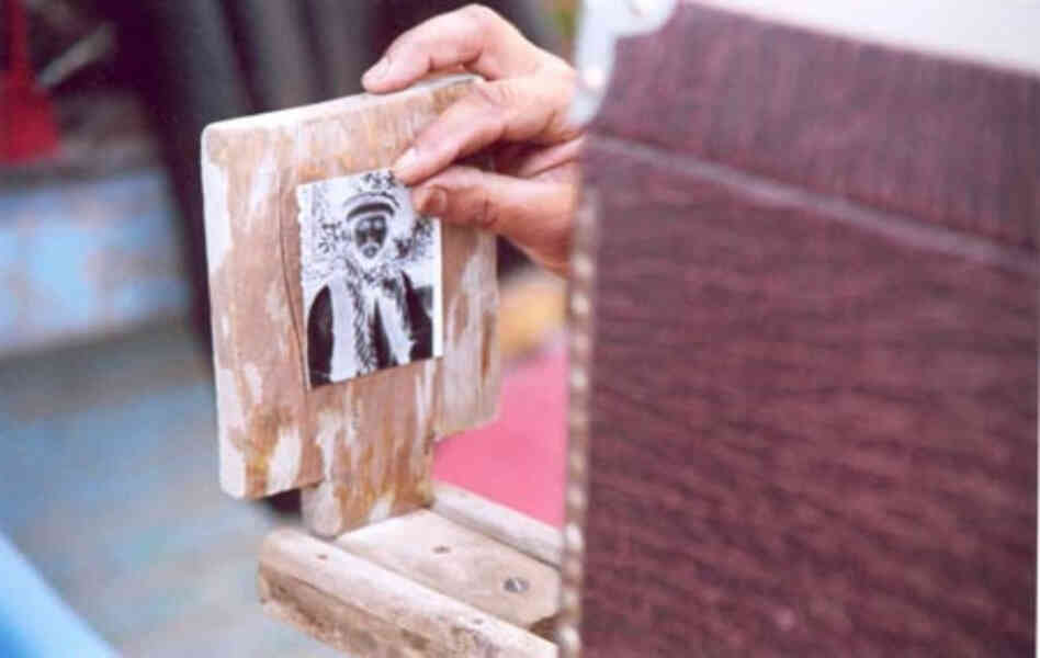Birk has his photo taken. After the first exposure, the photographer mounts the resulting negative image to be photographed again, creating the positive image.