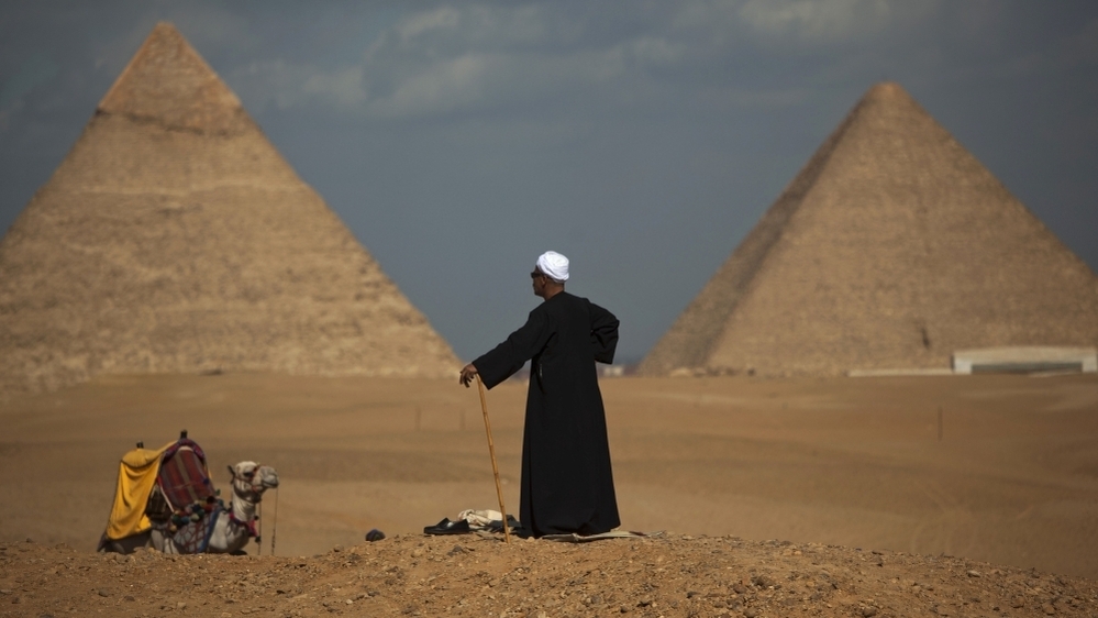 Egyptian camel driver Gamal, 54, waits for tourists near the pyramids,  in Giza, Egypt,  Jan. 31.