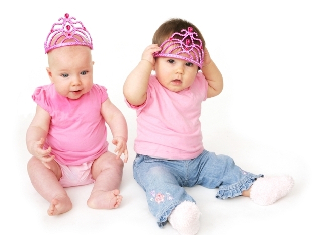 Infant girls wear pink T-shirts and matching tiaras. 