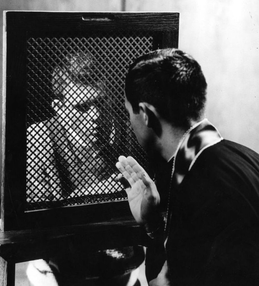 A priest hearing a confession, circa 1950. (Photo by Three Lions/Getty Images)