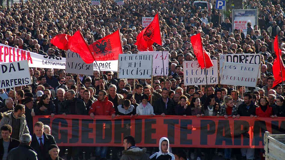 Opposition supporters carrying banners and Albanian national flags participate in an anti-government protest in the town of Vlora, Albania, on Feb. 4. Opposition supporters carrying banners and Albanian national flags participate in an anti-government protest in the town of Vlora, Albania, on Feb. 4.