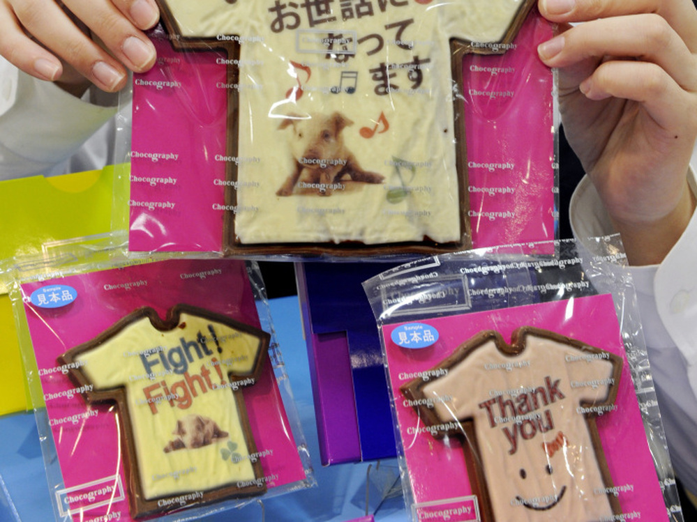 An employee at Tokyo store Message de Rose displays Valentine's Day chocolates at the Takashimaya department store's "Amour du Chocolat" event.