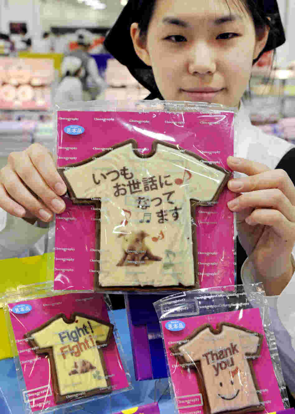 An employee at Tokyo store Message de Rose displays Valentine's Day chocolates at the Takashimaya department store's "Amour du Chocolat" event.