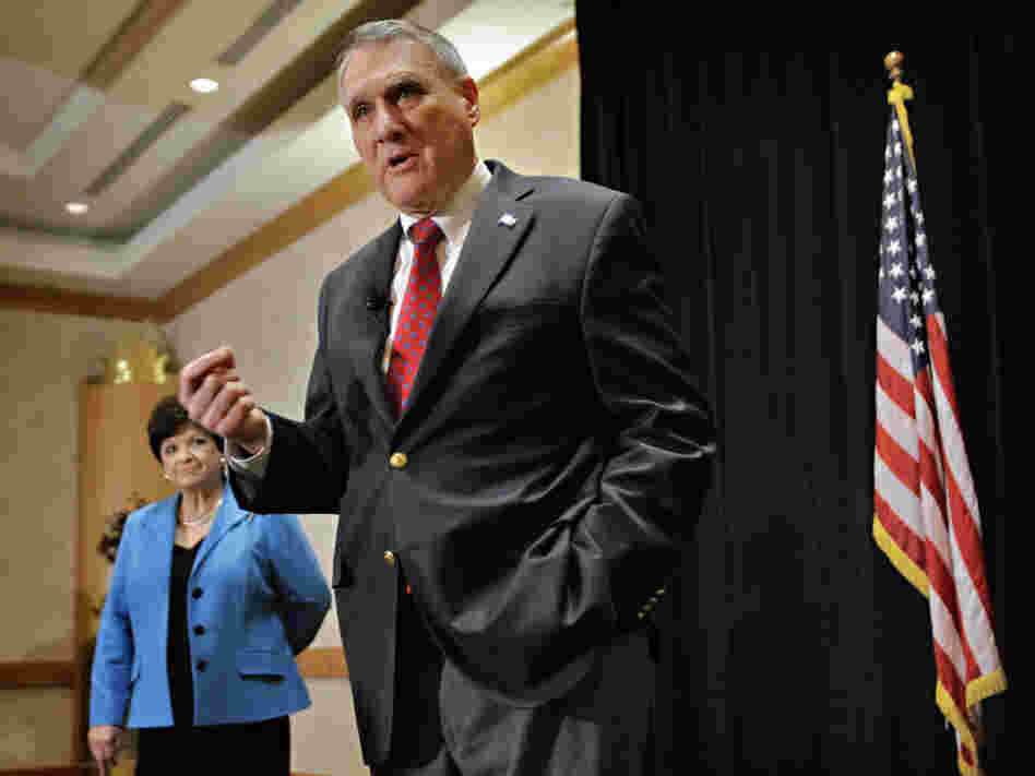 Sen. Jon Kyl in Phoenix announcing his retirement as wife, Caryll Kyle, listens, Feb. 10, 2011.