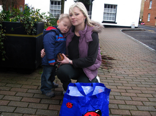 Sarah Richardson and her son, Harry, return a bag of books to the Stony Stratford Library. She took out the books as part of a protest against the possible closure of the library.