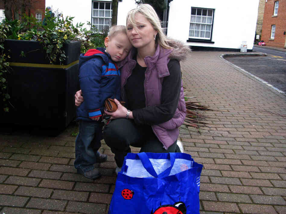 Sarah Richardson and her son, Harry, return a bag of books to the Stony Stratford Library. She took out the books as part of a protest against the possible closure of the library.