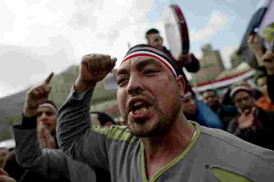 Egyptian anti-goverment demonstrators shout in Cairo's Tahrir Square on Friday, the 18th consecutive day of protests demanding the resignation of Mubarak. 