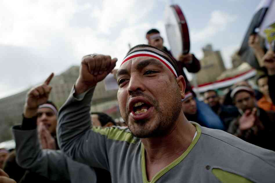 Egyptian anti-goverment demonstrators shout in Cairo's Tahrir Square on Friday, the 18th consecutive day of protests demanding the resignation of Mubarak. 
