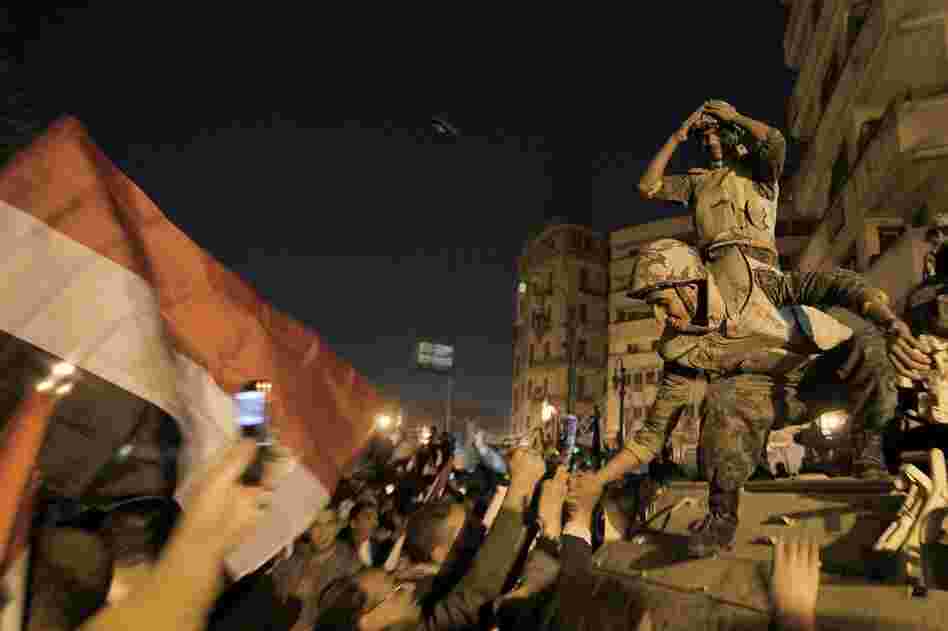 Egyptian soldiers celebrate with anti-government protesters. Vice President Omar Suleiman announced the military will take control over affairs of state. 