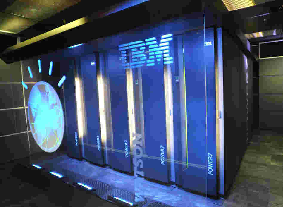 Watson is made up of 10 refrigerator-sized racks of computers. It has around a million books in its memory, and it's around 32,000 times faster than a laptop.