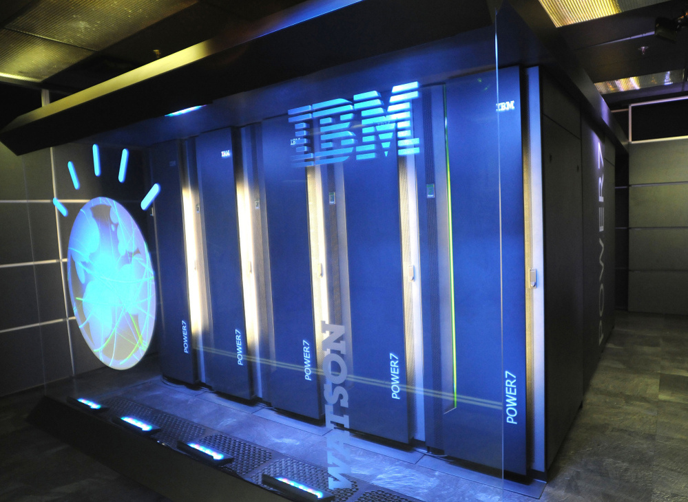 Watson is made up of 10 refrigerator-sized racks of computers. It has around a million books in its memory, and it's around 32,000 times faster than a laptop.