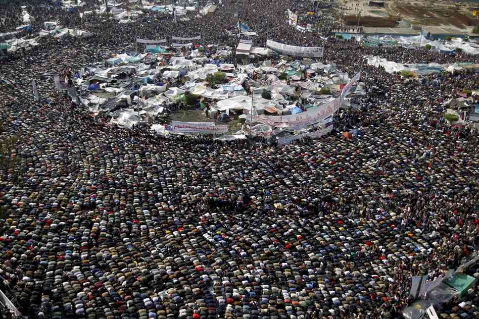 Protesters take a break for prayer amid the protests in Tahrir Square on Friday. 