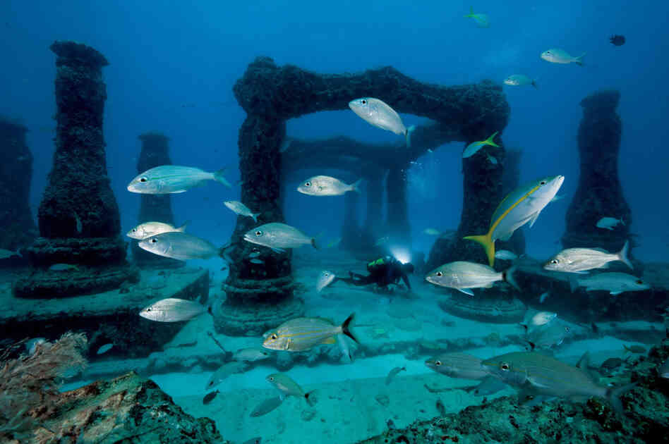 Fish swim through Neptune Memorial Reef, an underwater cemetery with decorative arches and columns installed on the ocean floor off Miami Beach. The cremated remains of about 200 people have been mixed with cement and molded into memorial sculptures. Fish swim through Neptune Memorial Reef, an underwater cemetery with decorative arches and columns installed on the ocean floor off Miami Beach. The cremated remains of about 200 people have been mixed with cement and molded into memorial sculptures.