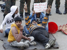Egyptian protesters hold a placard reading "We will not leave the square until we get all our demands," as they sit in front of soldiers in Cairo's Tahrir Square on Sunday. Egyptian protesters hold a placard reading "We will not leave the square until we get all our demands," as they sit in front of soldiers in Cairo's Tahrir Square on Sunday.