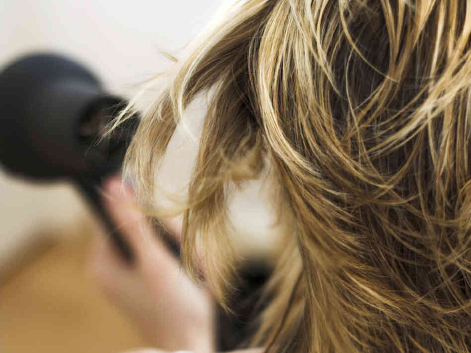 Woman drying hair. Woman drying hair.