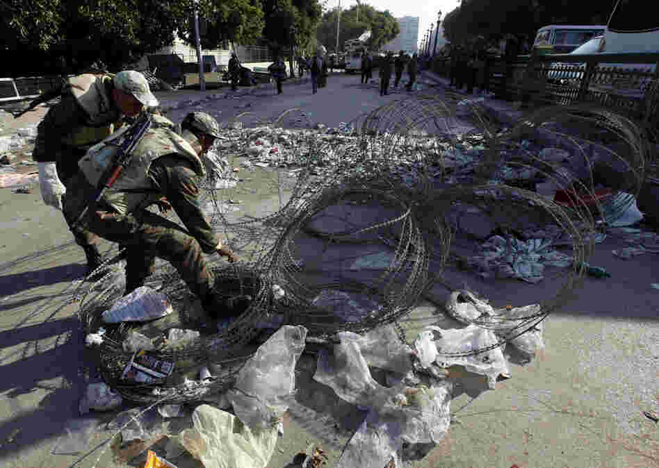 Soldiers remove barbed wire at one of the main entrances to Tahrir Square. 