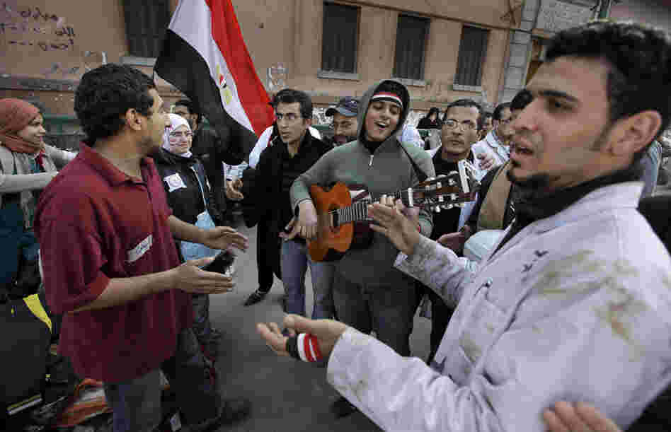 Protesters sing by a field medical clinic near the barricades in Tahrir Square. 