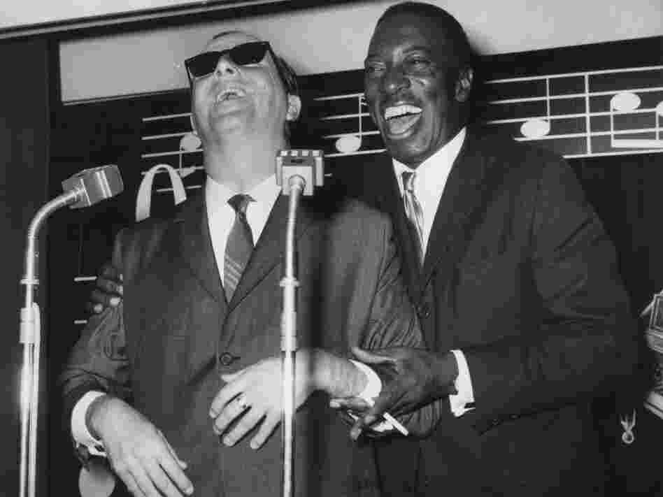 British jazz pianist George Shearing (left) and American singer Joe Williams attend a press reception in London in 1962 before beginning a tour of Britain together.
