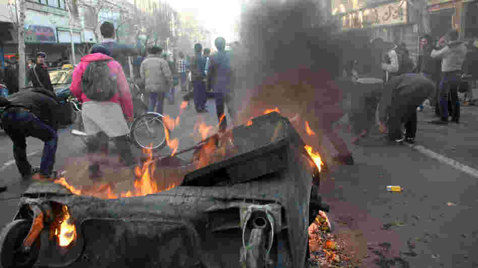 This photo, taken by an individual not employed by the Associated Press and obtained by the AP outside Iran, shows Iranian protestors attending  an anti-government protest as a trash dumpster is set on fire, in Tehran, earlier today (Feb. 14, 2011).