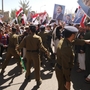 Yemeni security forces stand between pro-regime supporters (right) and  anti-government protesters (unseen in picture) during demonstrations  outside Sanaa University in the Yemeni capital on Tuesday.