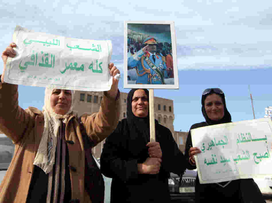 Libyan pro-government supporters hold a portrait of leader Moammar Gadhafi during a rally Wednesday in Tripoli.